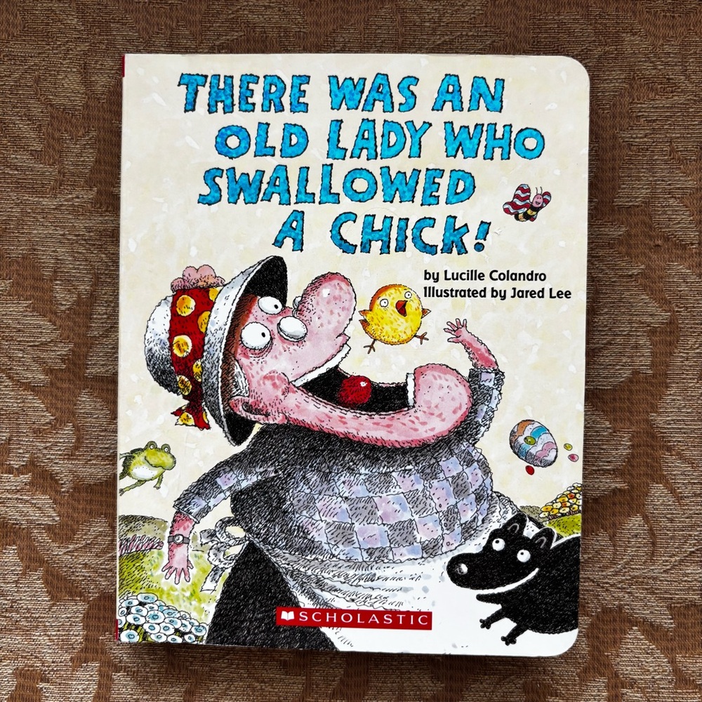 There Was an Old Lady Who Swallowed a Chick! Board Book by Lucille Colandro